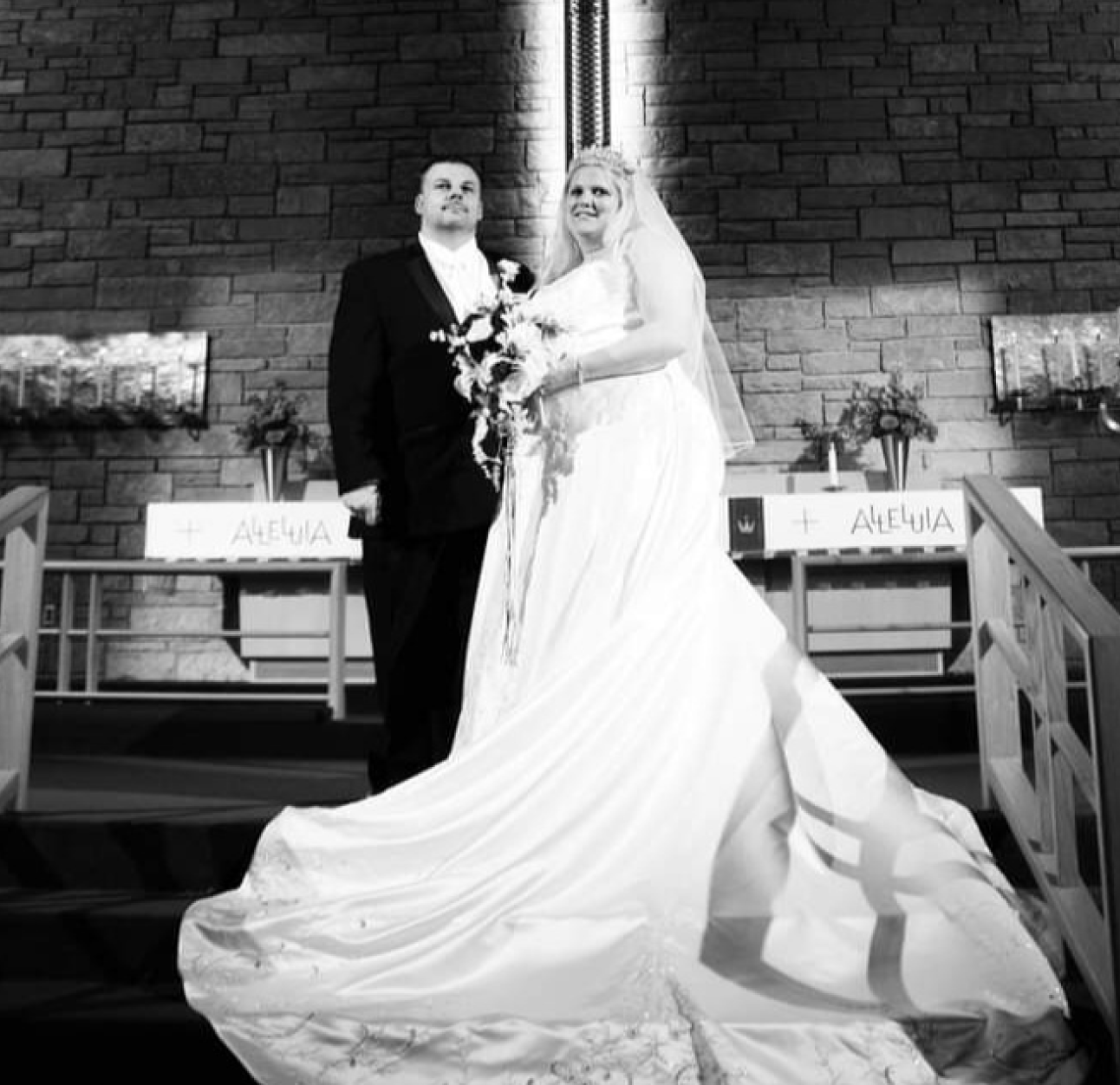 PAH patient, Rochelle, and her husband Tim dressed in wedding attire, standing on an altar on their wedding day