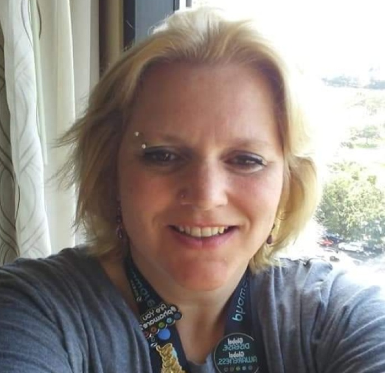 PAH patient, Rochelle, taking a selfie in front of a sunny window at home