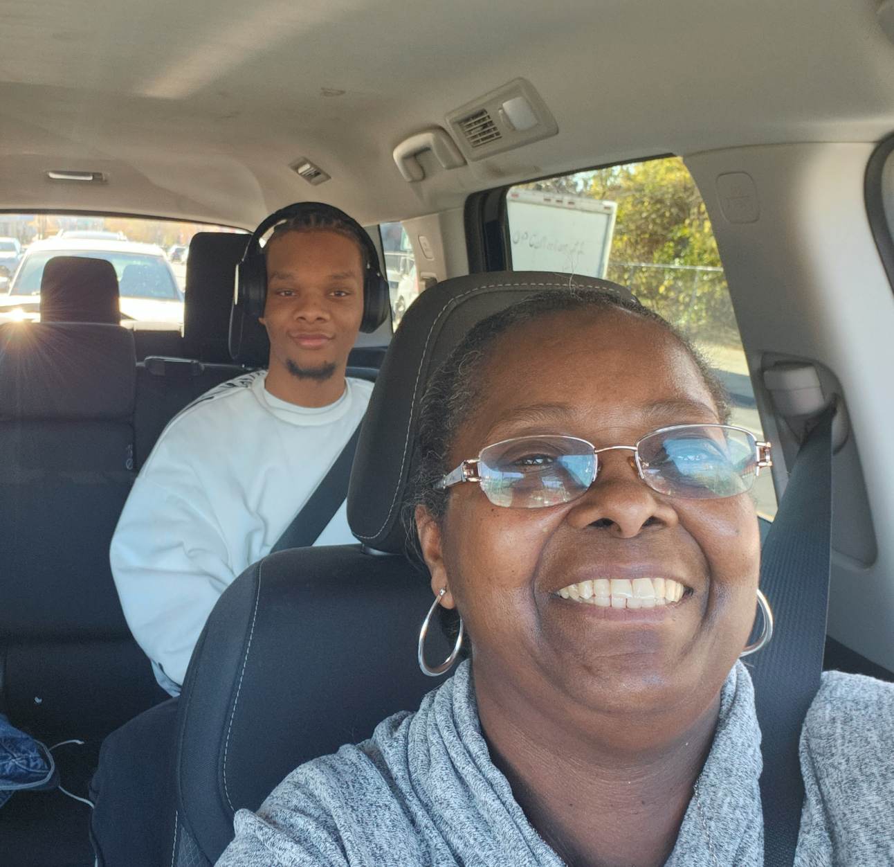 Female PAH patient, Nola, smiling in the front seat of a car with her nephew smiling in the back seat