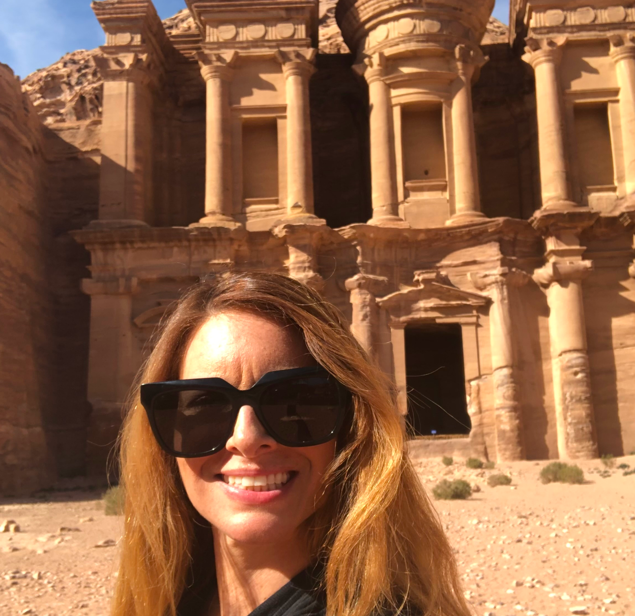 PAH patient, Katie, wearing sunglasses in a selfie outside the ancient city of Petra in Southern Jordan